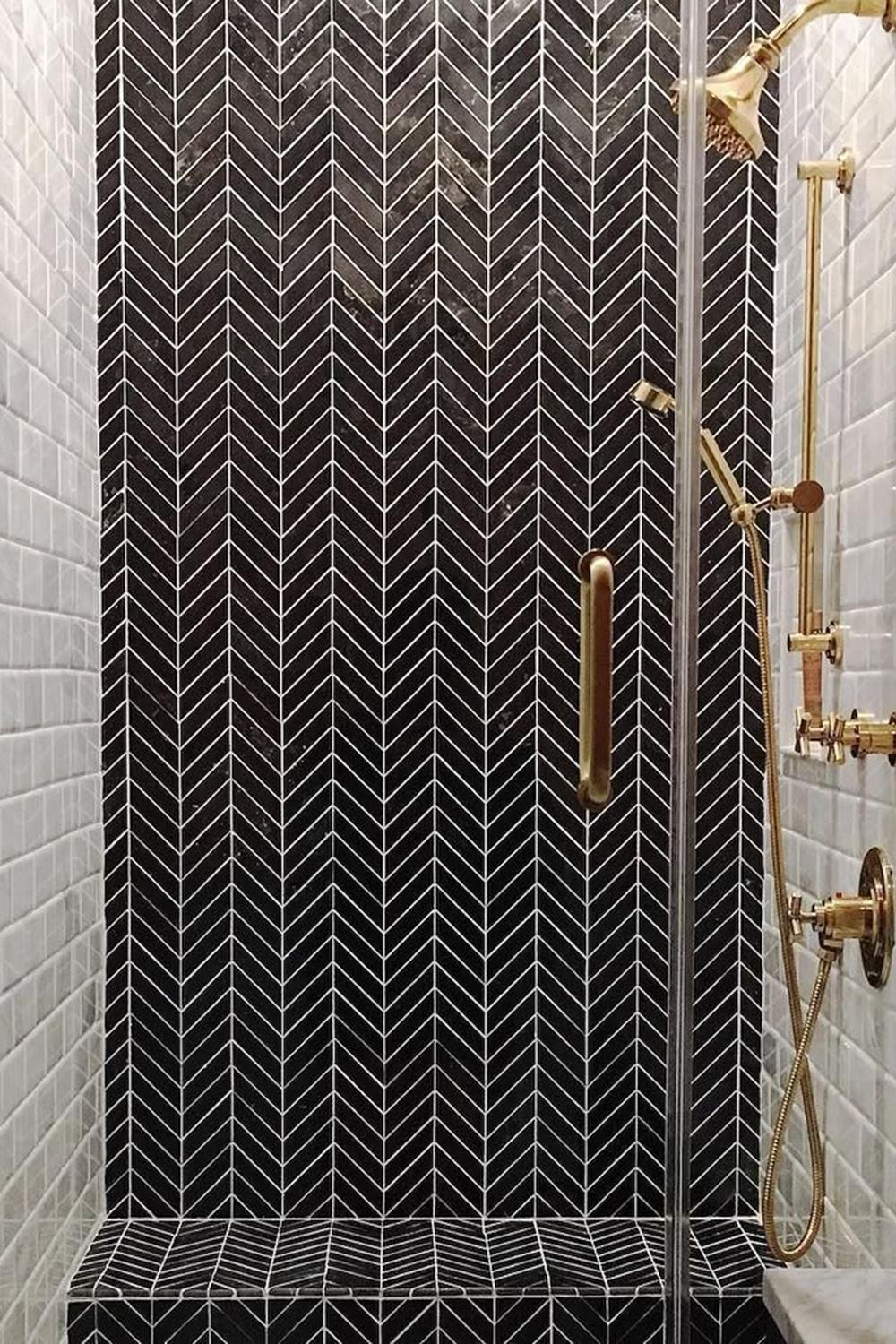 Stylish bathroom shower space featuring herringbone black tiles.