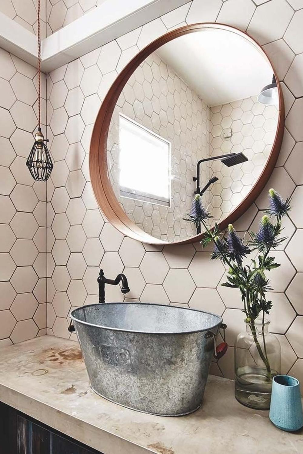 Modern rustic bathroom featuring light neutral hexagon tiles and rustic accents.
