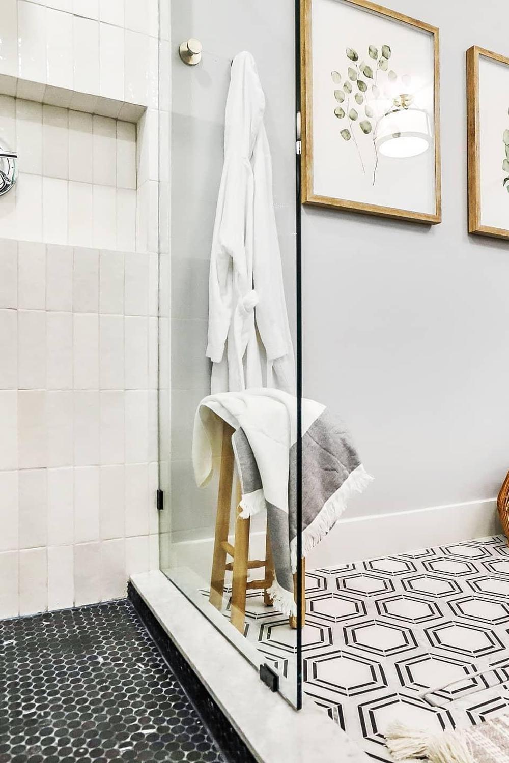 Modern bathroom with black and white hexagon tiles in a geometric pattern.