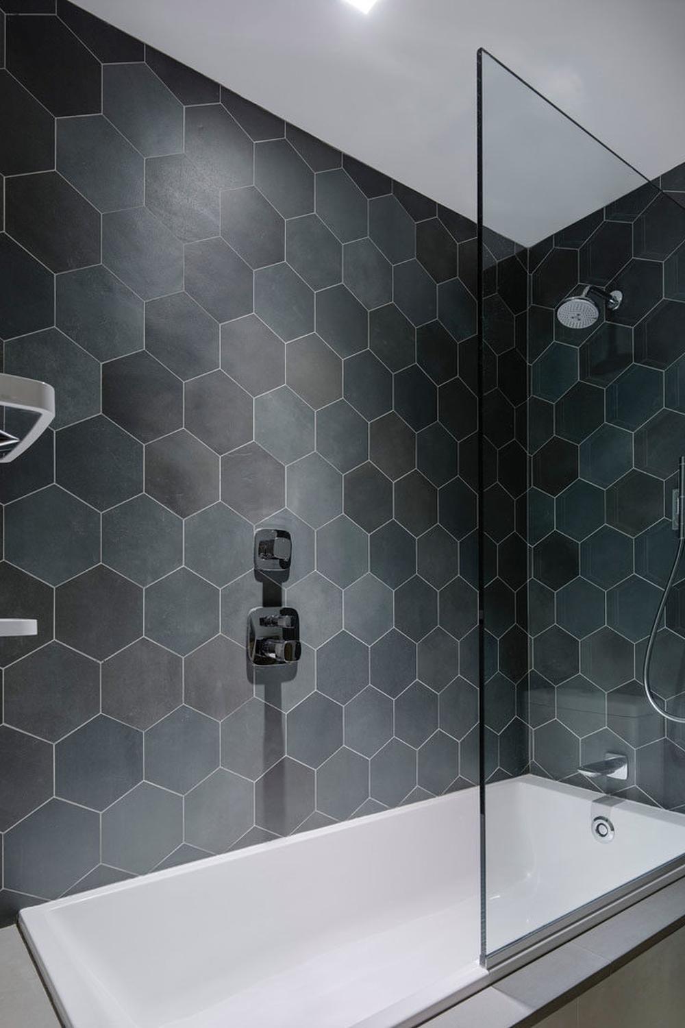 Elegant dark gray hexagon tiles enveloping a modern shower area