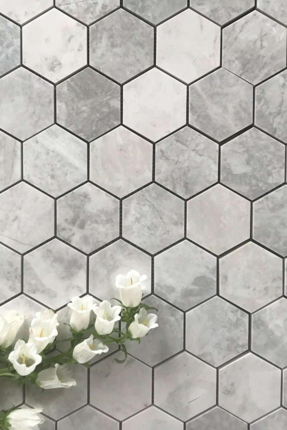 Modern bathroom with gray and white hexagon tiles enriched with floral accents