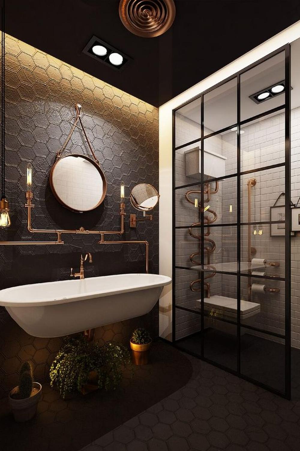 A stylish industrial bathroom with a dark color palette, hexagonal tiles, and a freestanding white bathtub.