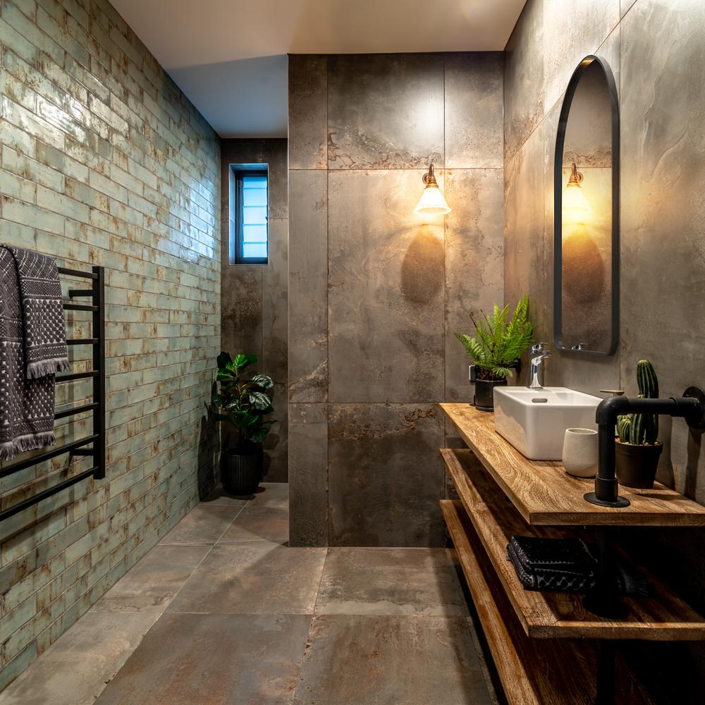 An industrial bathroom blending muted earth tones with modern tiles and modern fixtures.