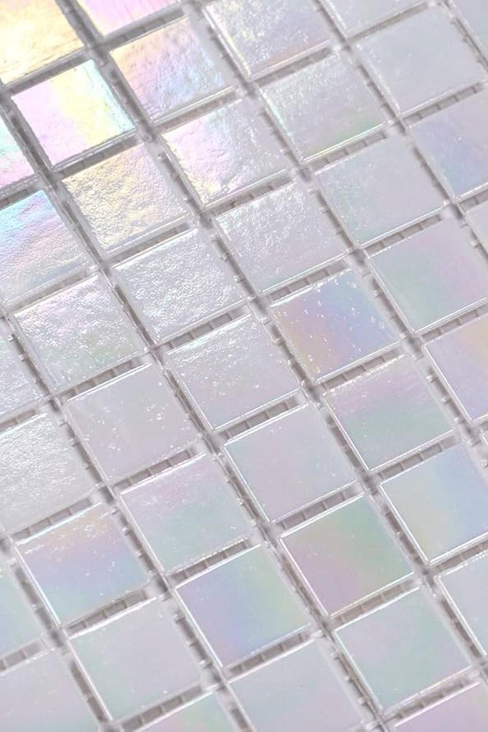 Azulejos iridiscentes en un patrón de rejilla, mostrando tonalidades de rosa, azul y verde.