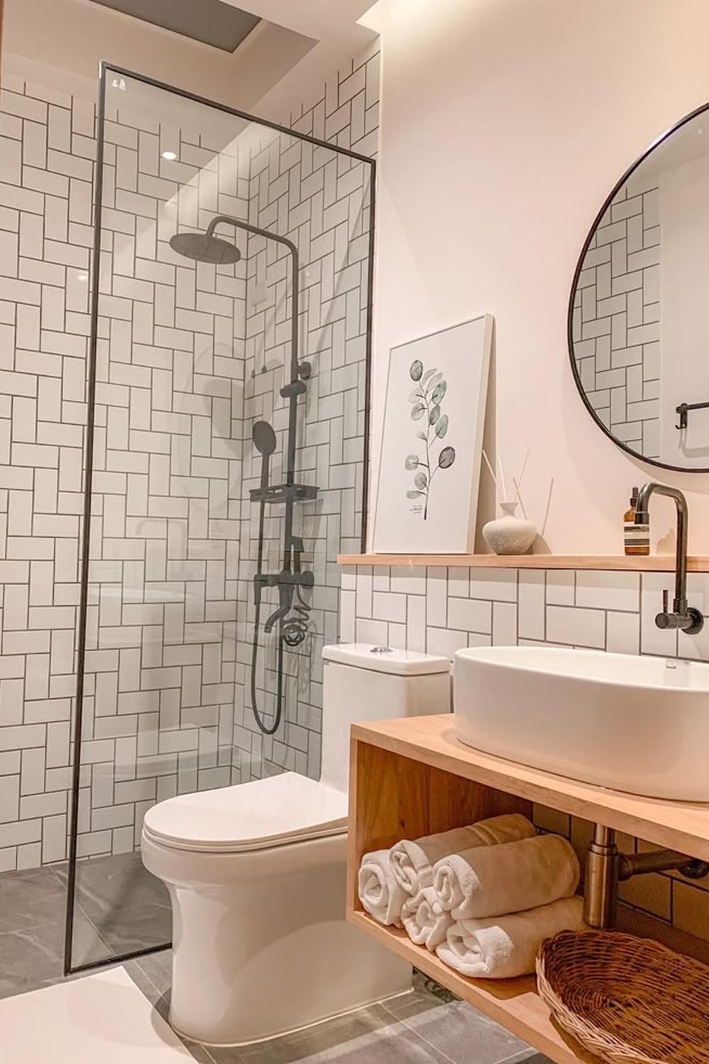 A modern bathroom featuring a beautiful glass-enclosed shower area with elegant fixtures and décor.
