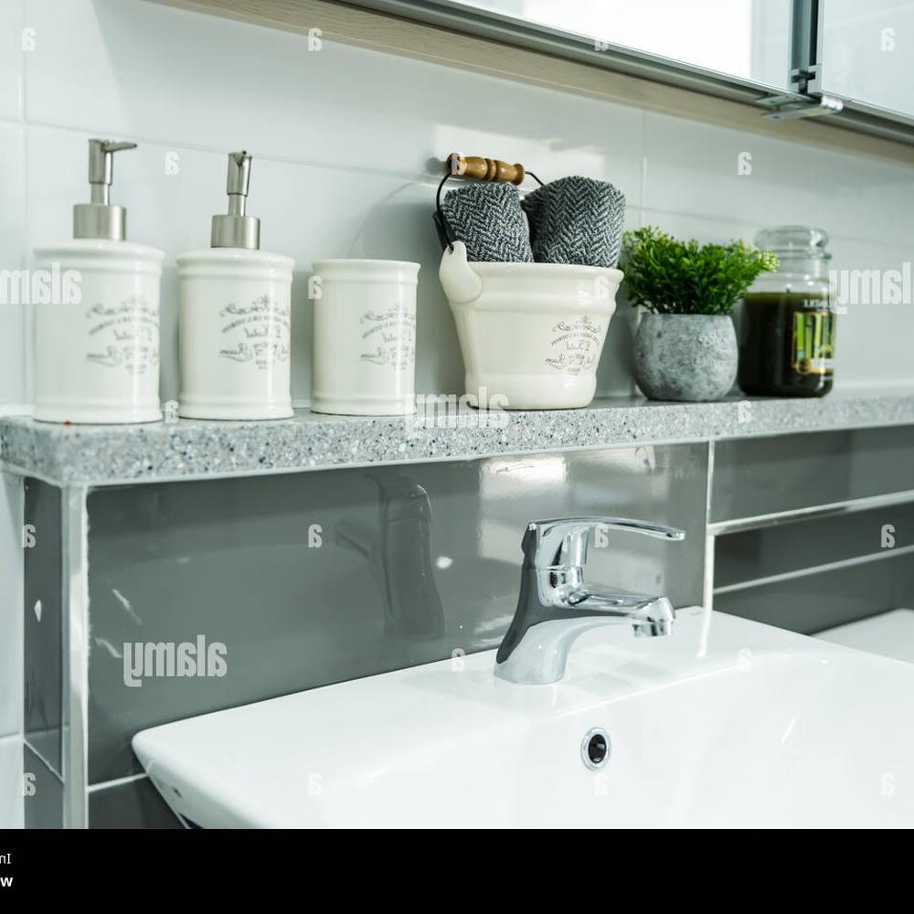 A modern bathroom layout featuring a sleek countertop and organized storage elements.