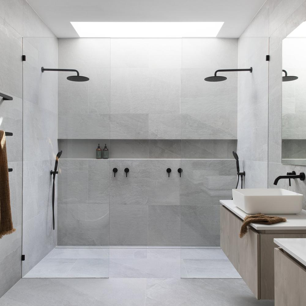 Modern bathroom with light gray tiles and sleek fixtures