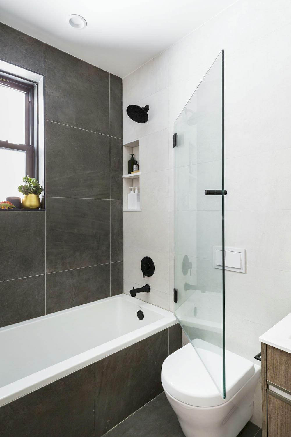 Stylish bathroom featuring large format gray tiles and a seamless design