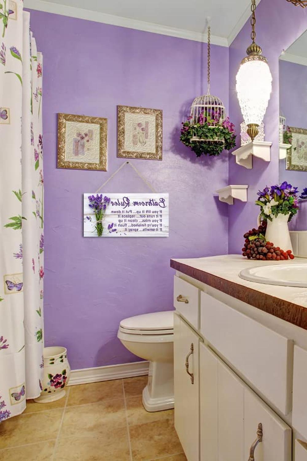 Charming bathroom with vibrant purple walls and artistic decor elements.