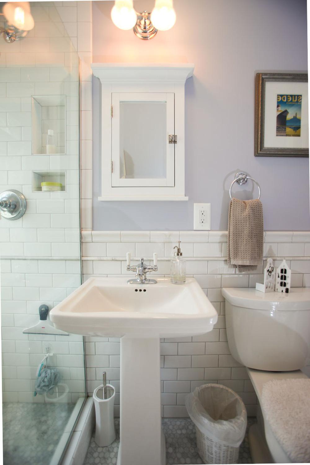 Elegant modern bathroom featuring pedestal sinks and contemporary design.