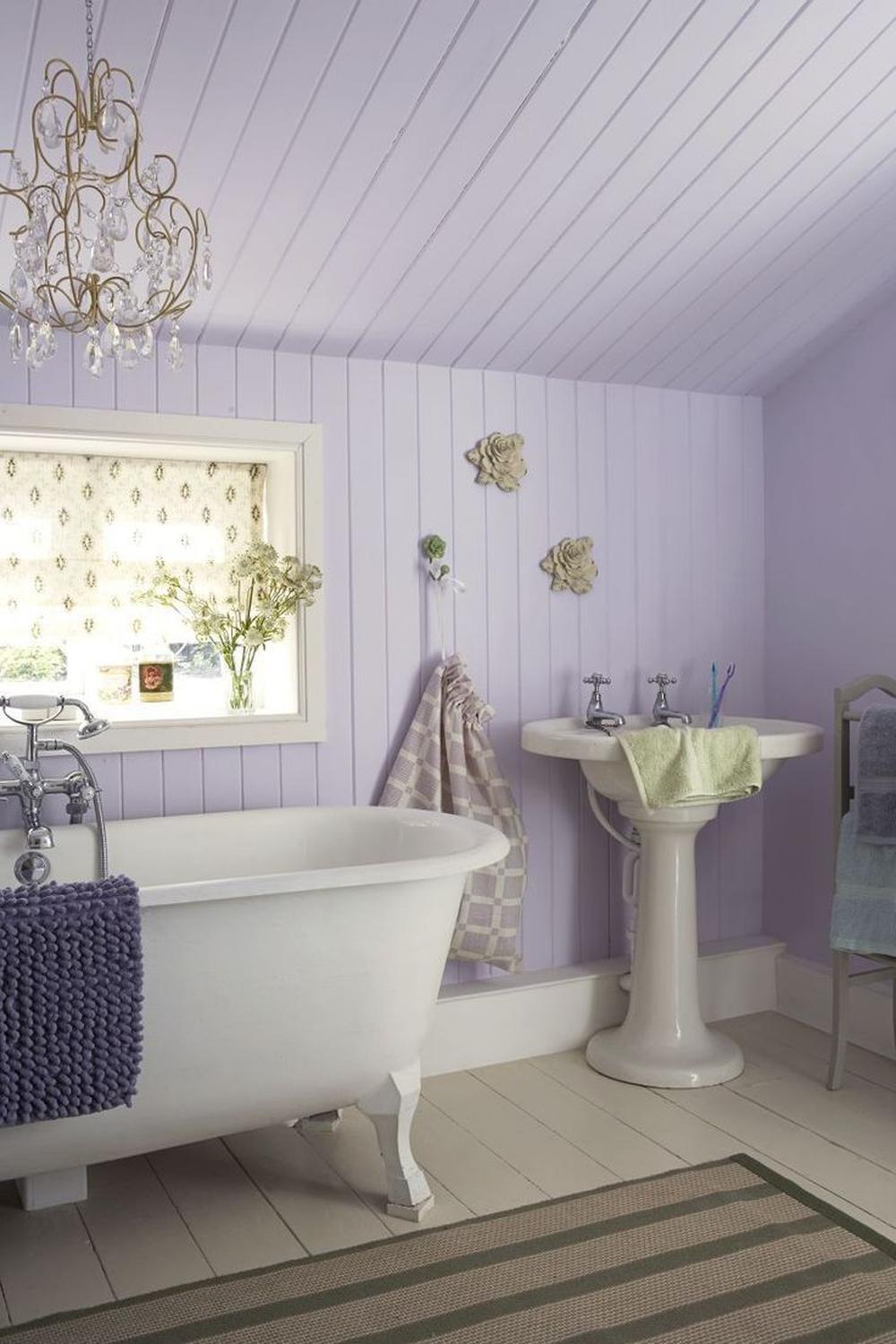 Vintage freestanding bathtub enhancing the charm of a lavender bathroom.