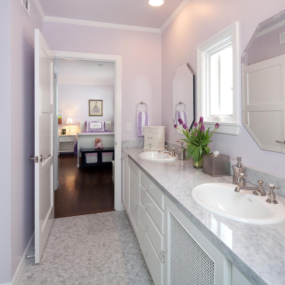 Chic bathroom design with marble accents and lavender undertones.