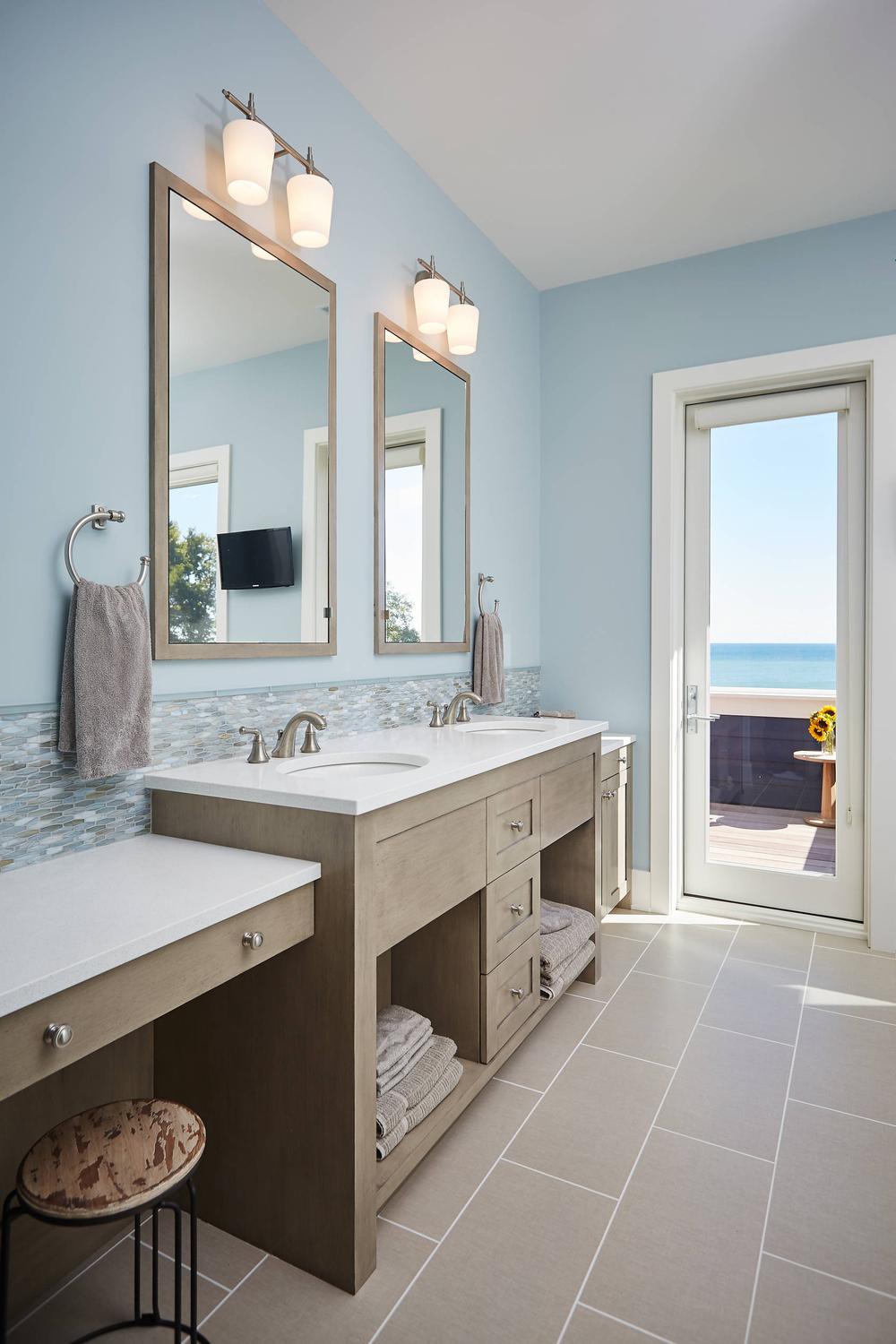 Stylish light blue bathroom with spacious double vanity