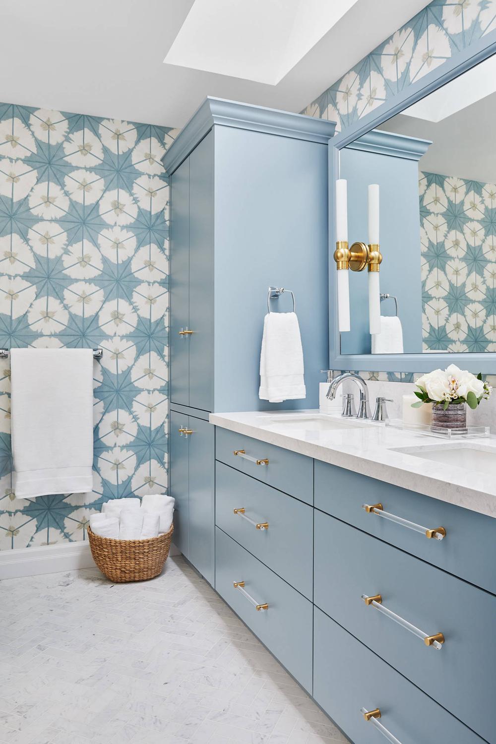 Light blue bathroom adorned with geometric floral wallpaper