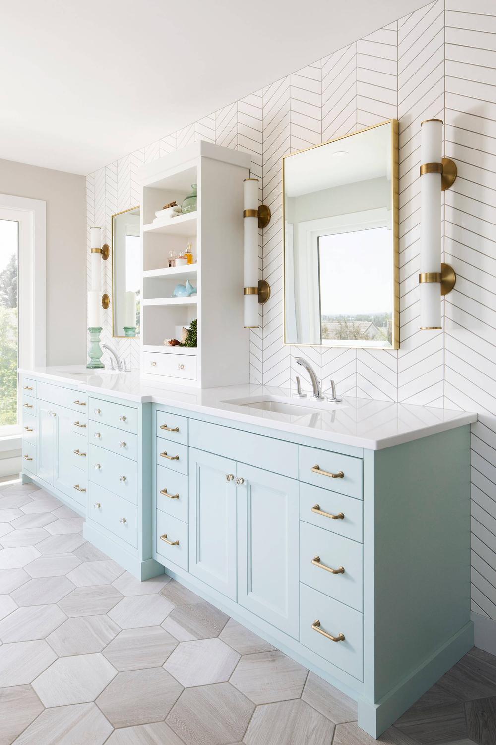 Light blue bathroom showcasing a double vanity and elegant décor