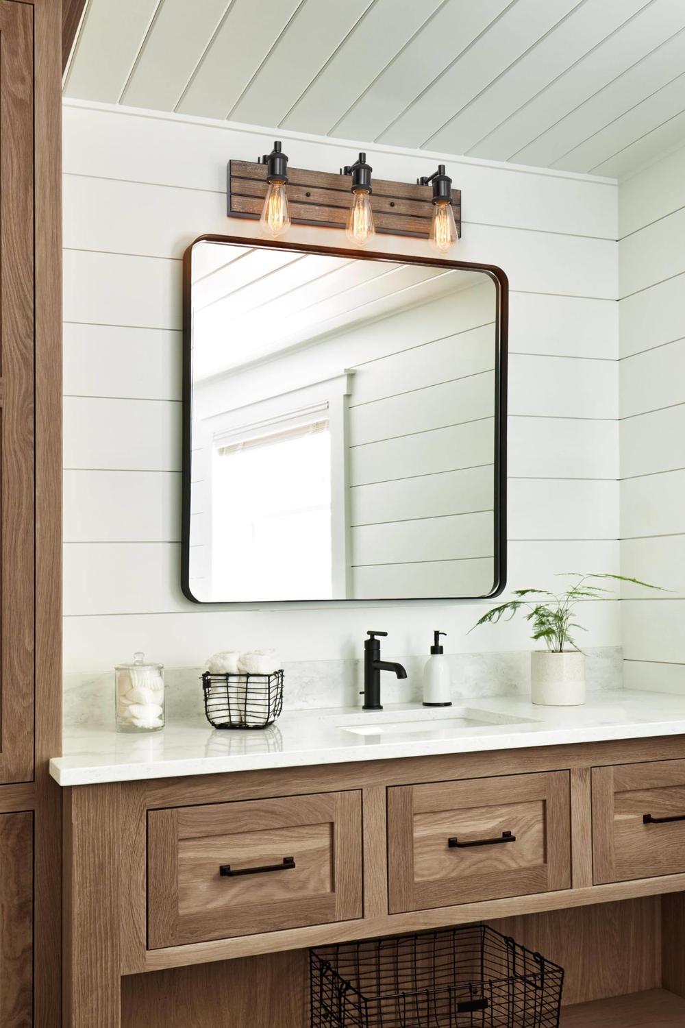 Elegant light wood bathroom vanity with brass finish.