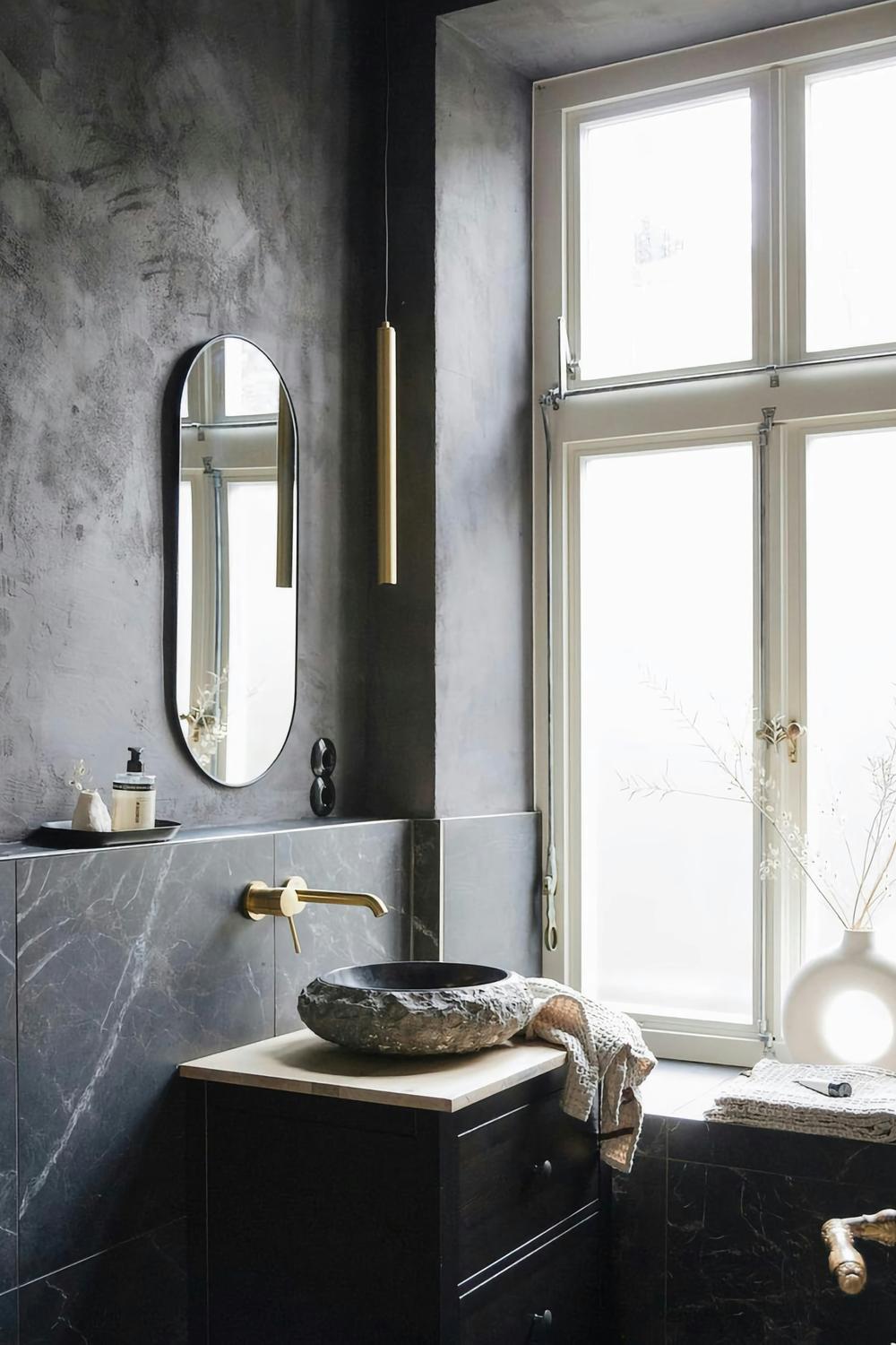 A bathroom featuring spacious natural light and elegant limewash wall finish.