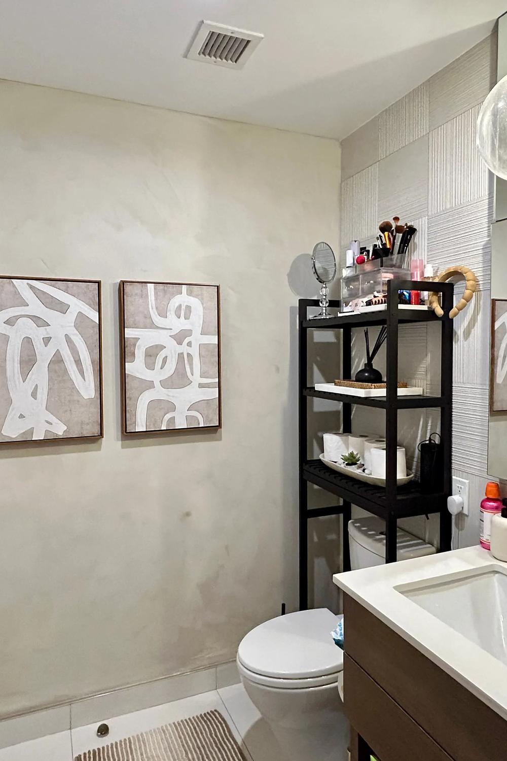 A minimalist bathroom emphasizing limewash walls with bold accent decor.