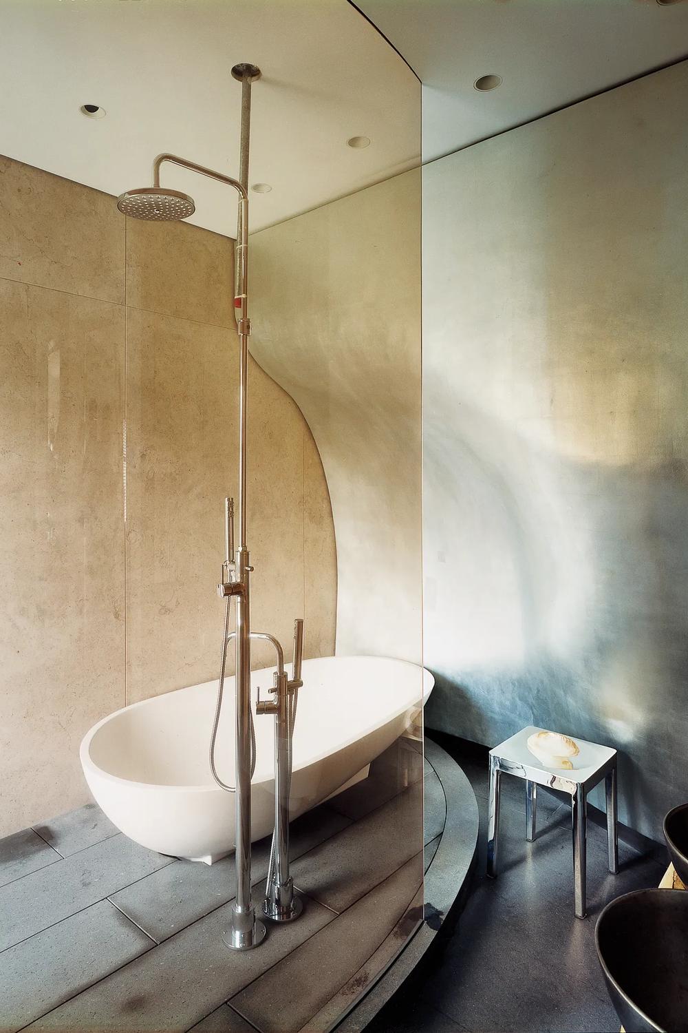 A spa-like bathroom featuring a freestanding oval bathtub and contemporary design.