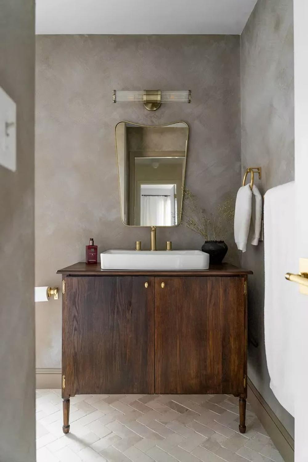 A contemporary bathroom showcasing warm limewash and textured woods.