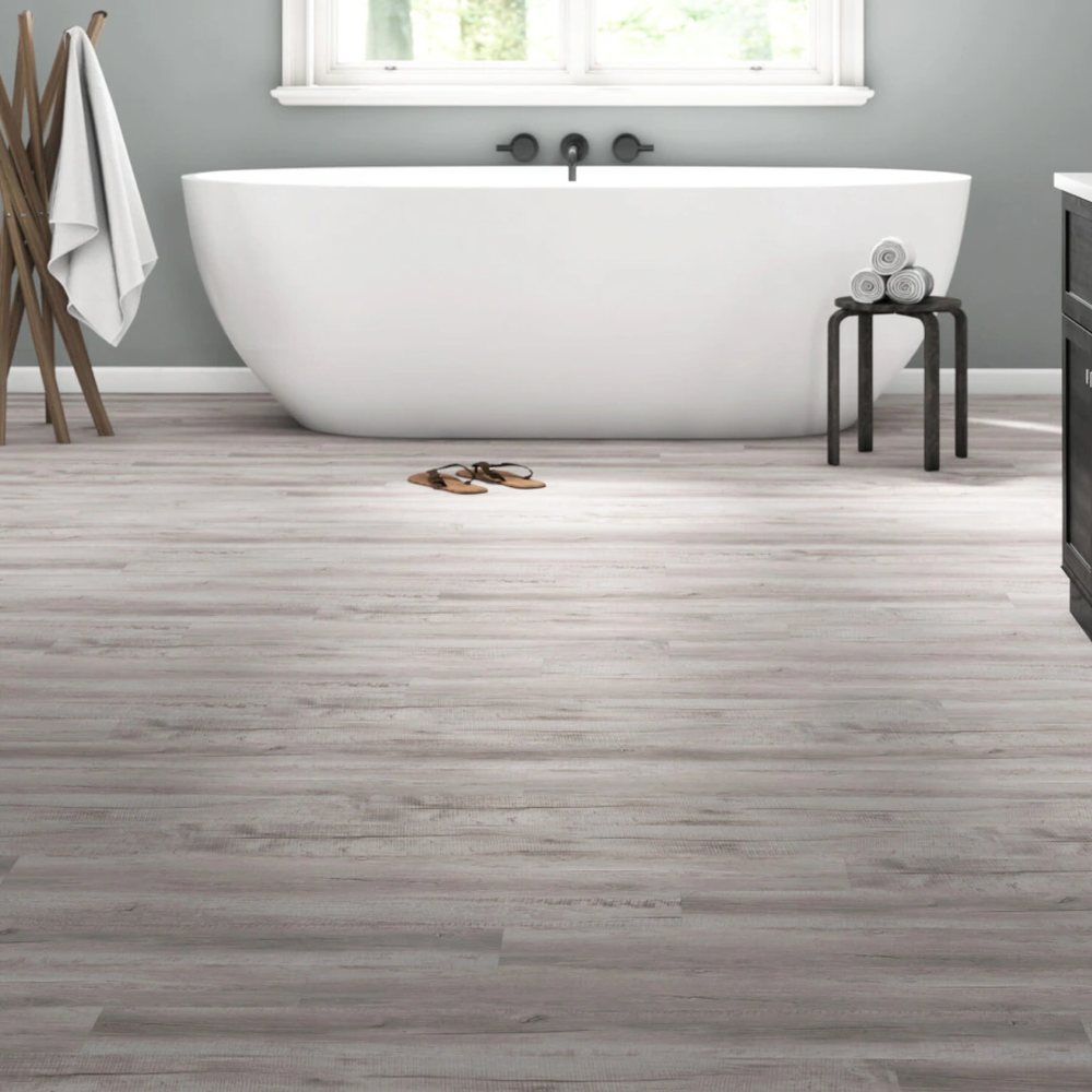 A sophisticated bathroom featuring natural wood-look luxury vinyl tile flooring and modern design elements.