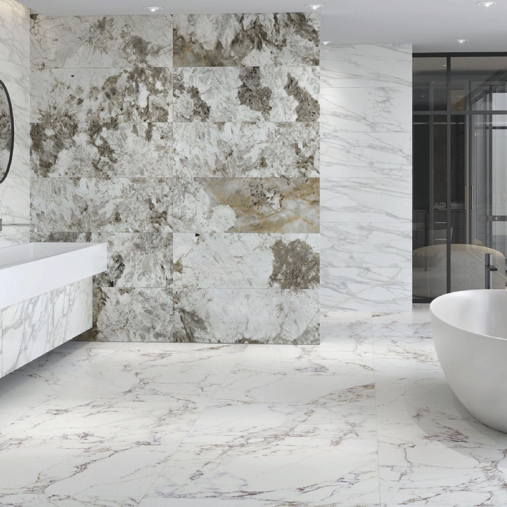 An elegant modern bathroom featuring mixed gray and white marble tile designs with a freestanding bathtub and wall-mounted vanity.