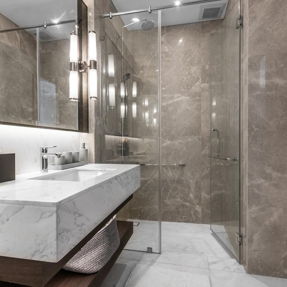 A sleek modern bathroom showcasing two integrated sinks and a freestanding bathtub.