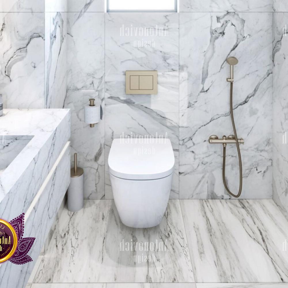 A chic modern bathroom featuring a rectangular vanity and minimalist decor with marble walls.