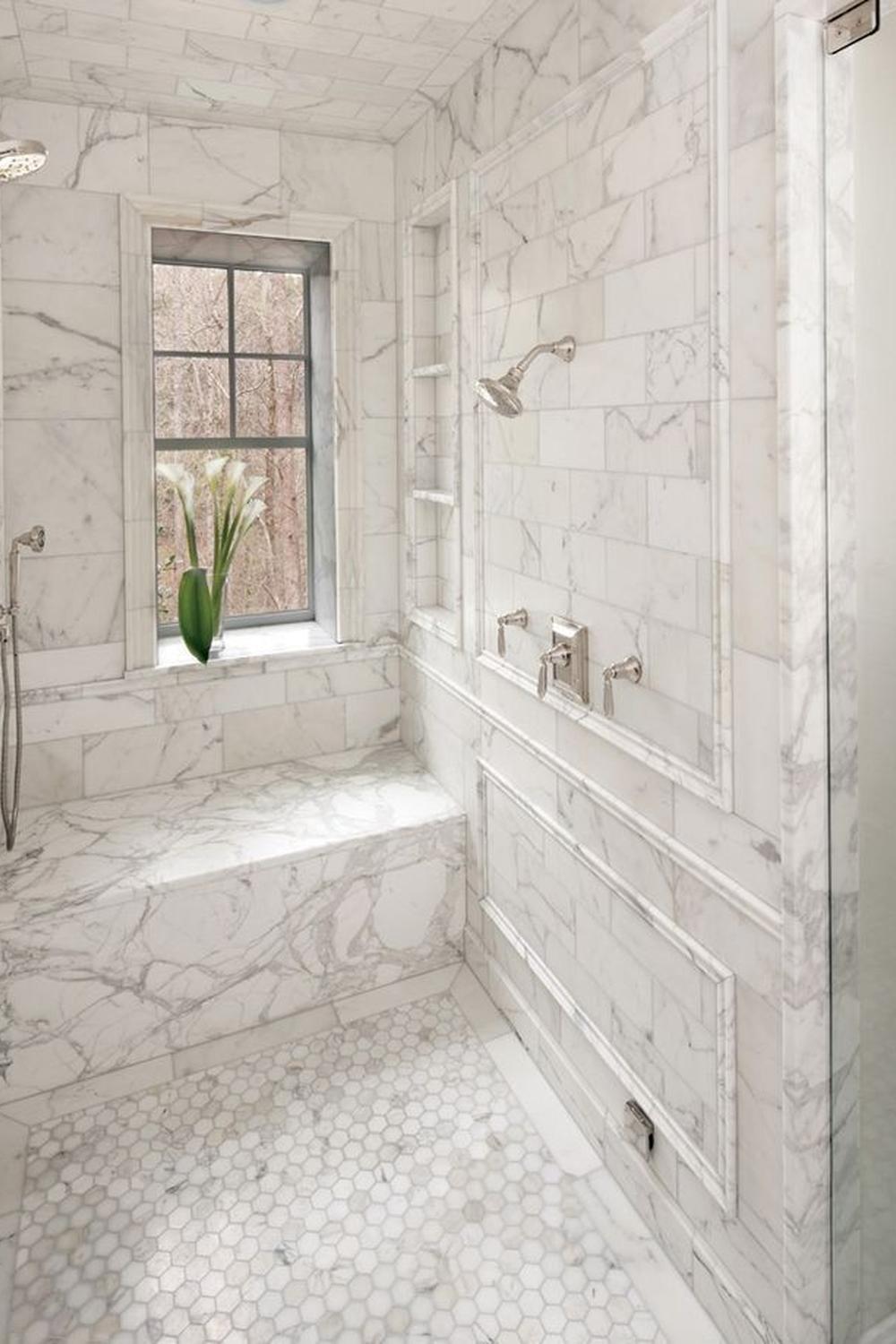 An elegant marble bathroom featuring seamless marble walls, highlighting a luxurious design.