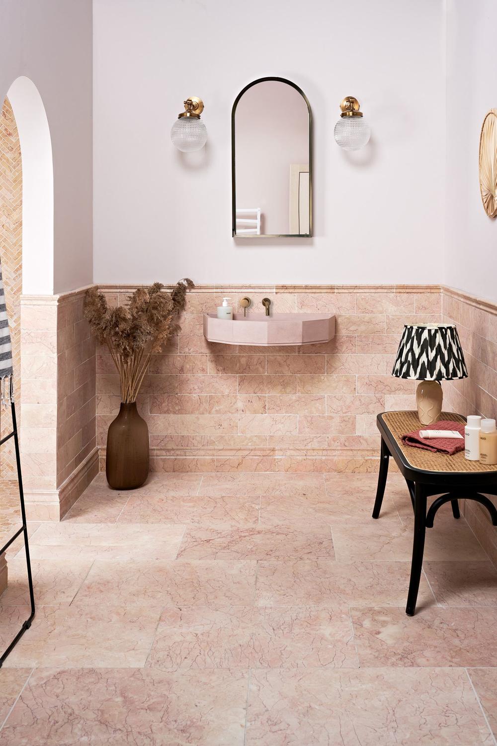 An elegantly designed marble bathroom featuring soft color palettes and warm lighting.