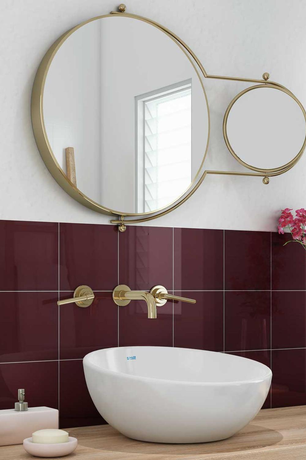 Modern bathroom design featuring maroon tiles and a sleek oval sink enhancing the stylish look.