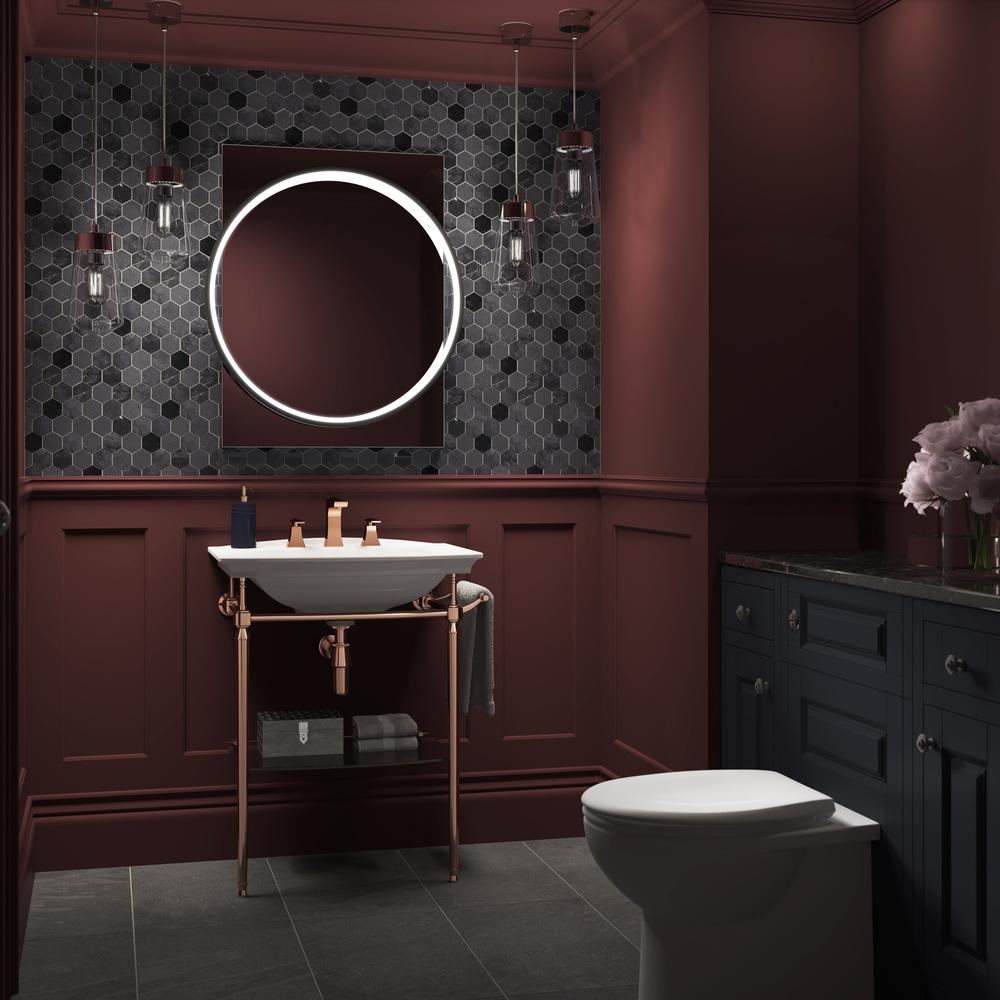 Elegant maroon bathroom featuring a striking mirror and stylish fixtures for a sophisticated vibe.