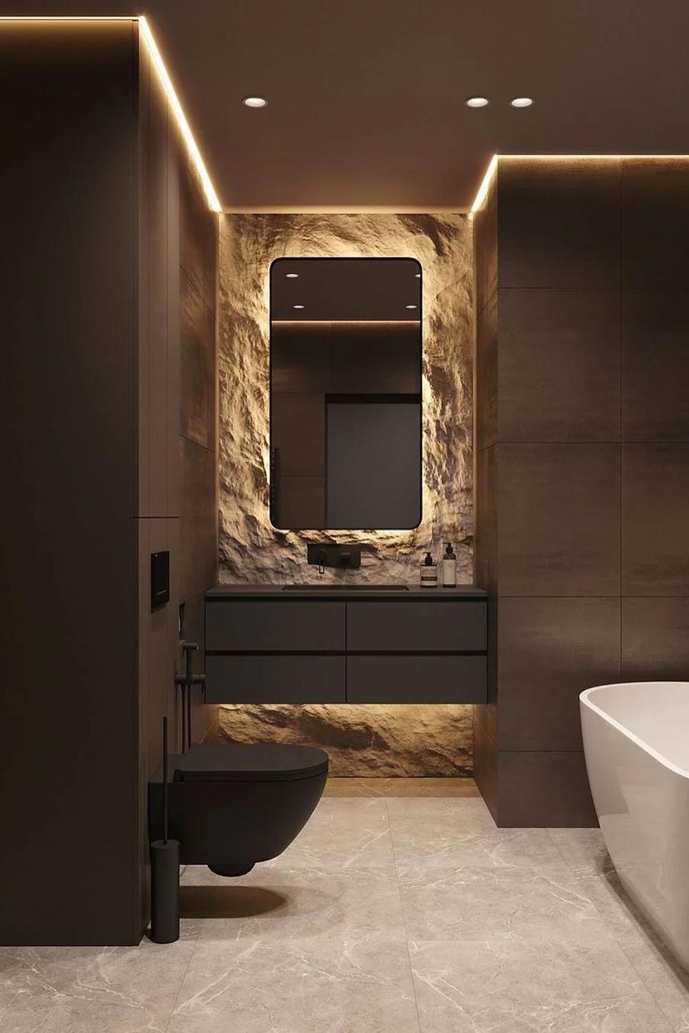 A sleek, minimalist masculine bathroom featuring dark colors and warm lighting.