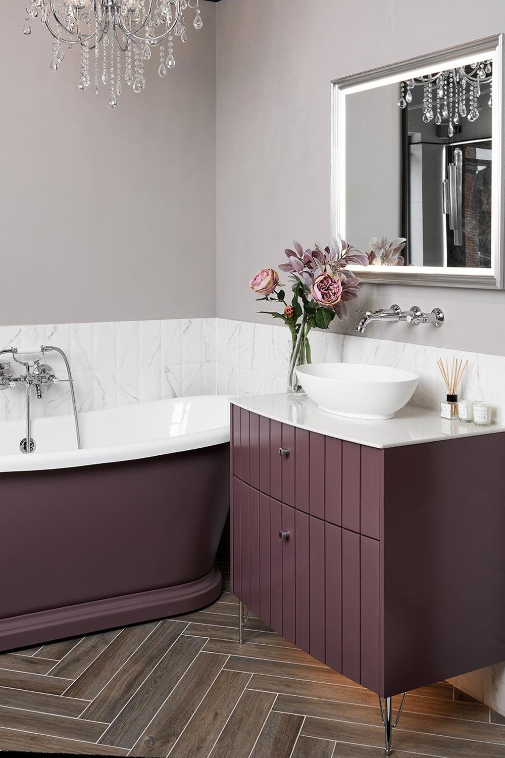 Luxurious freestanding mauve tub paired with elegant accents.