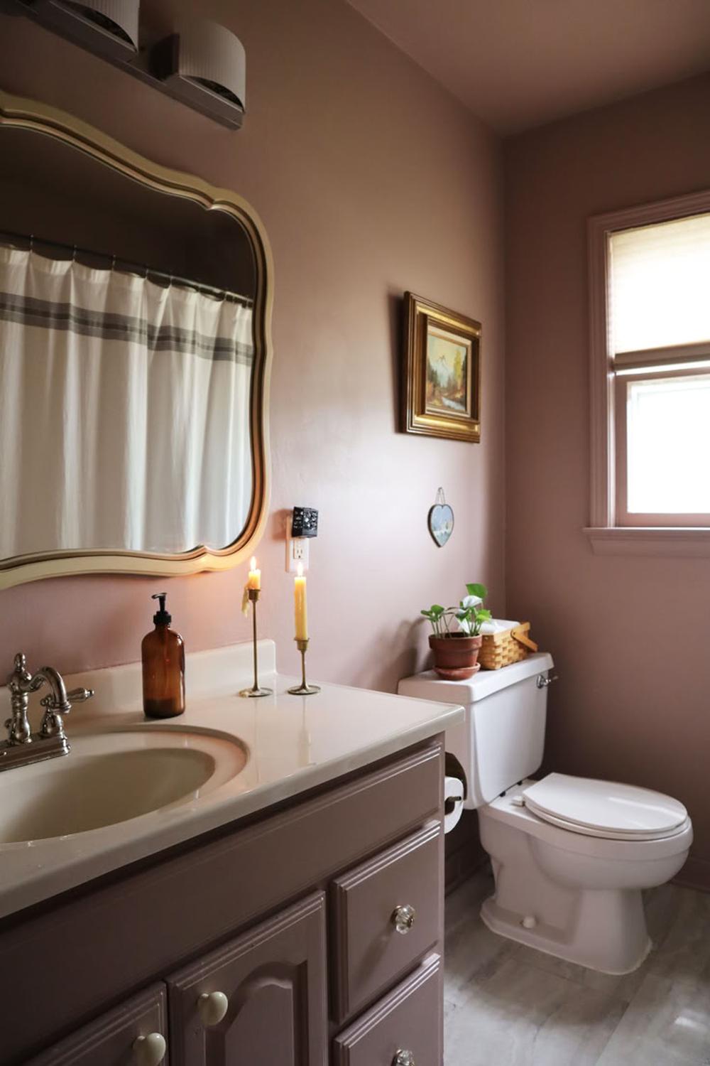 Soft mauve bathroom with magnificently ornate details and a cozy ambiance.