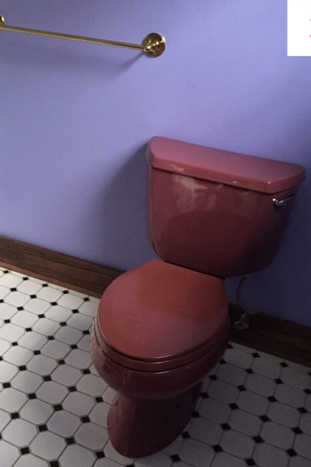 Cohesive mauve bathroom with modern contrasts including a deep mauve toilet.