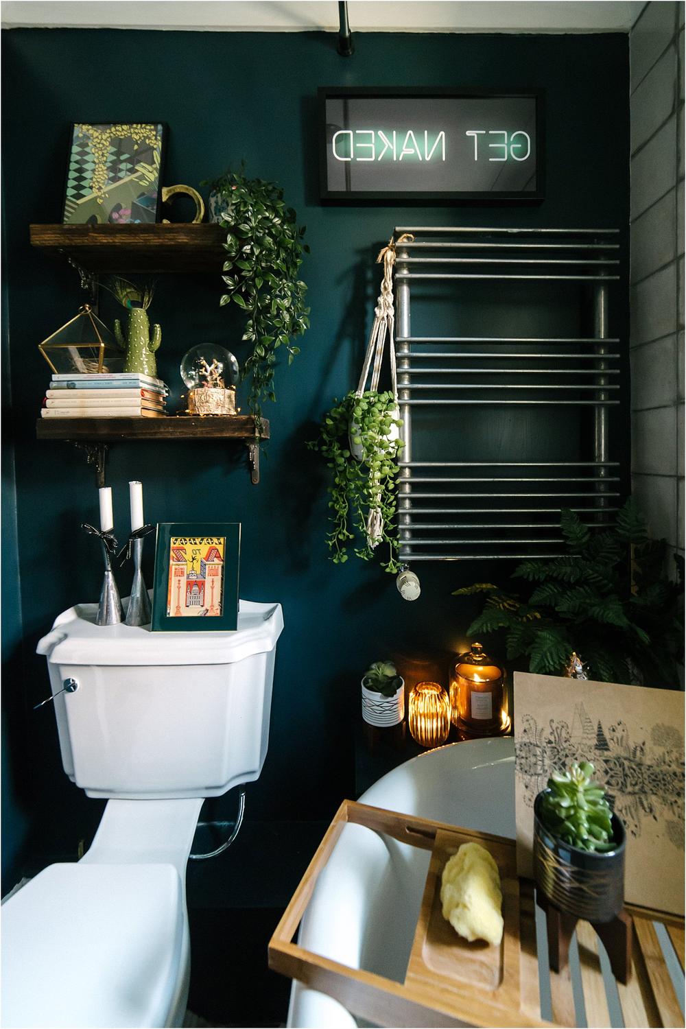 Maximalist bathroom with floral wallpaper and contemporary decor.