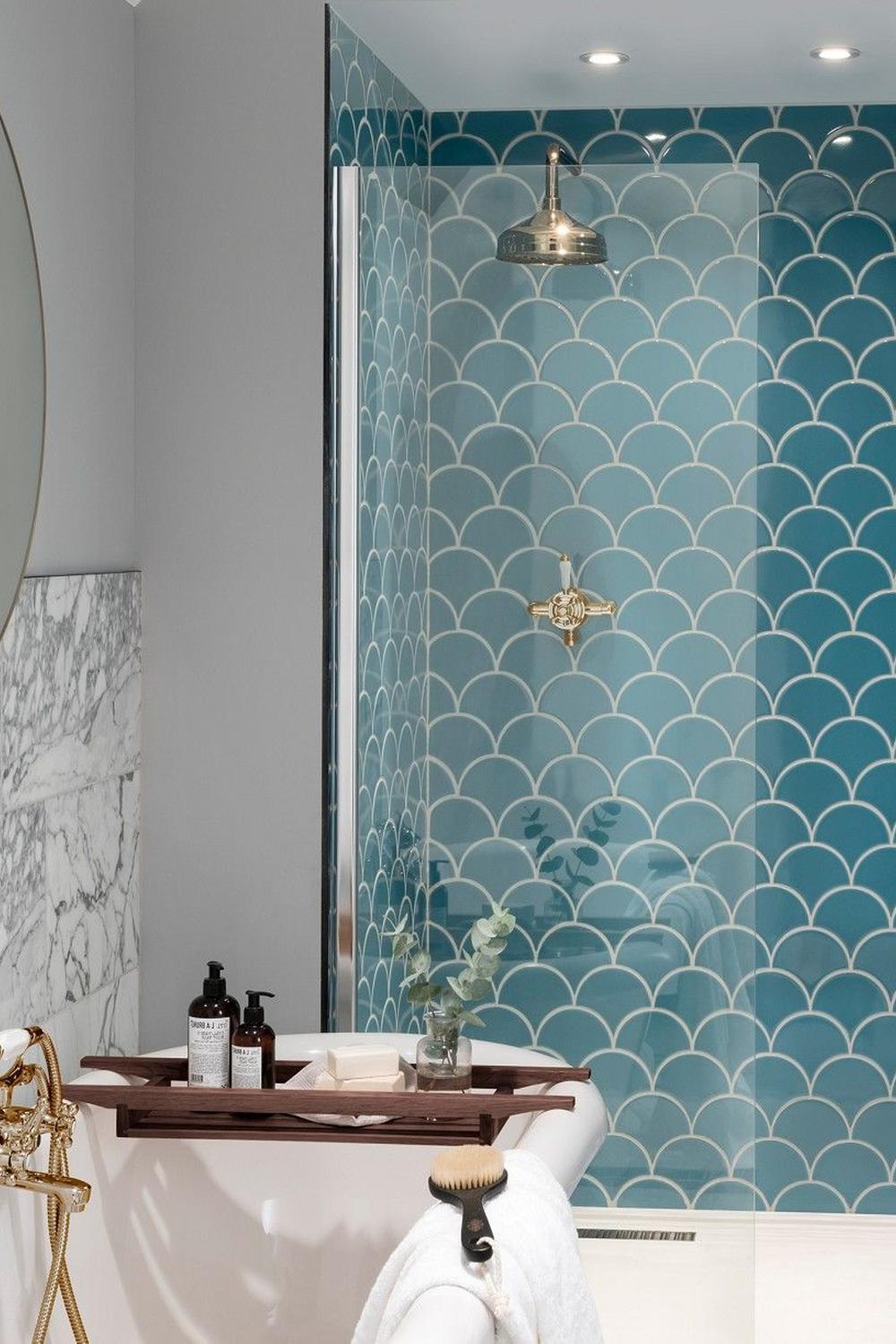 Stylish bathroom with scalloped tiles, vintage shower fixtures, and serene colors