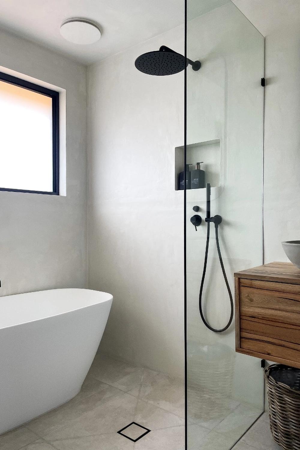 Serene bathroom equipped with layered textures, natural light, and a clean aesthetic.