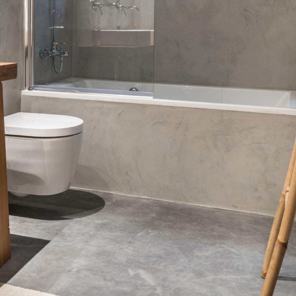 Tranquil bathroom featuring a minimalist aesthetic, micro cement finishes, and natural accents.