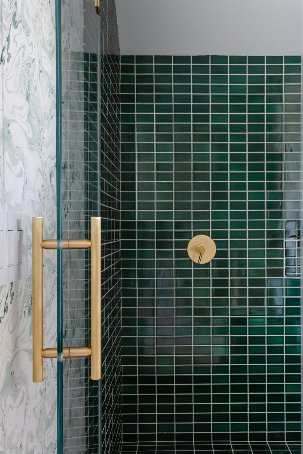 Contemporary bathroom with glossy mint green mosaic tiles and gold fixtures.