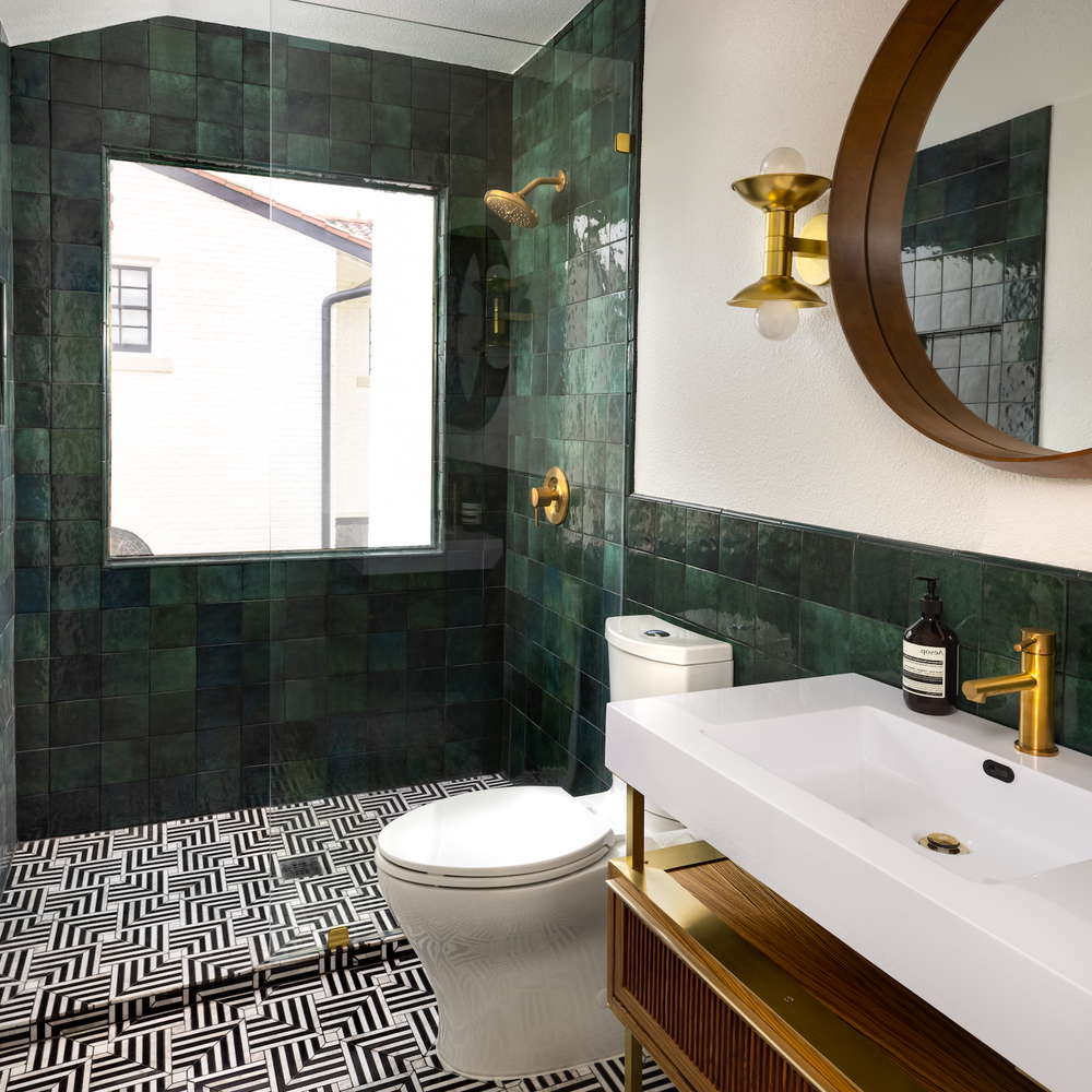 Stylish bathroom showcasing dark green tiles arranged in a mosaic pattern.