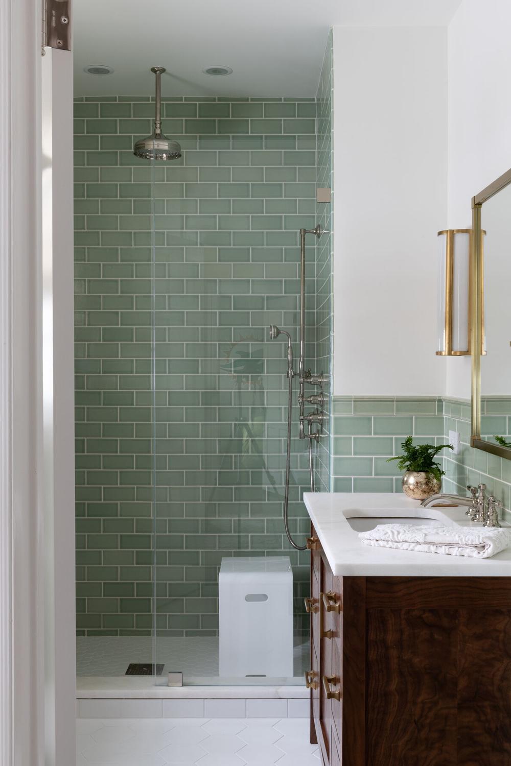 Contemporary bathroom displaying rectangular mint green subway tiles.