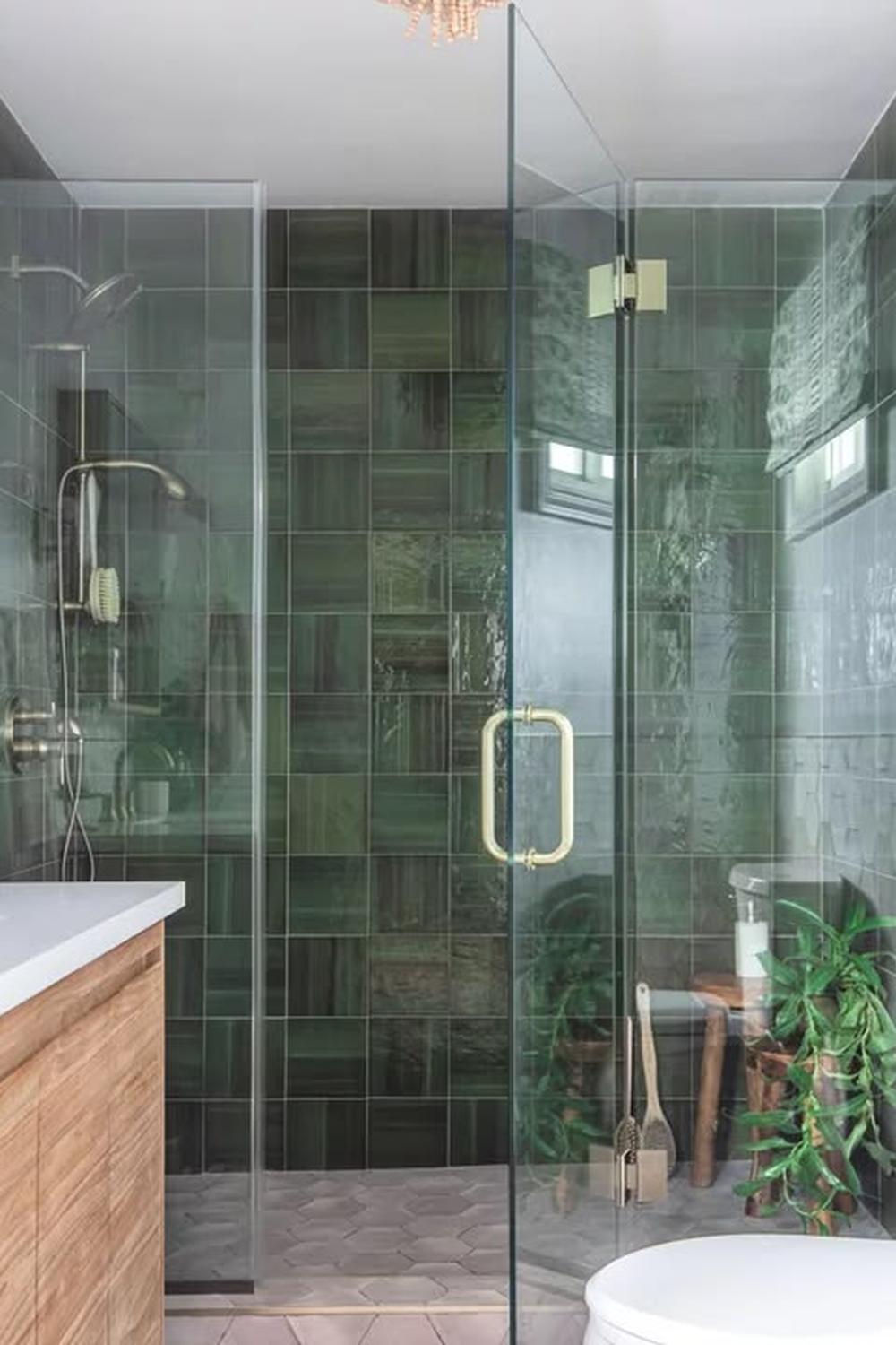 Luxurious bathroom featuring freestanding tub and mint green tiles.