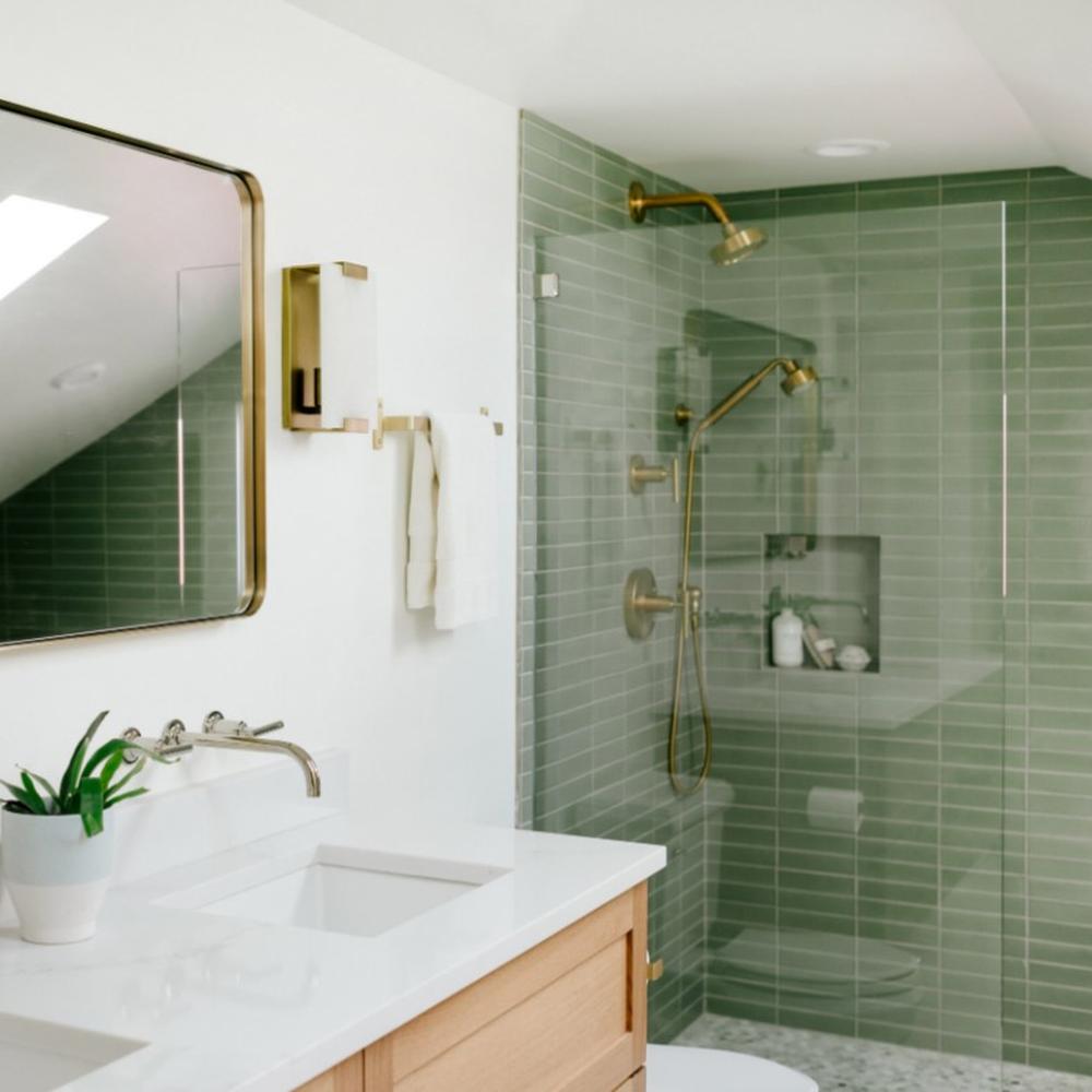 Elegant contemporary bathroom utilizing mint green tiles and unique forms.
