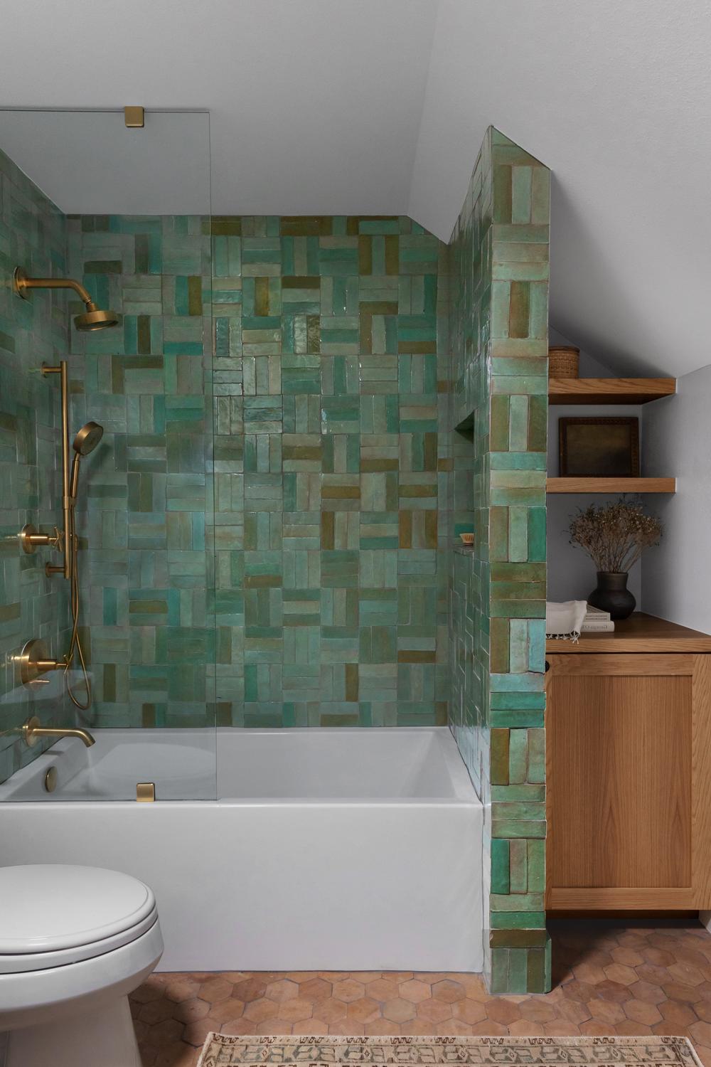 Contemporary bathroom featuring mint green tiles with playful designs.