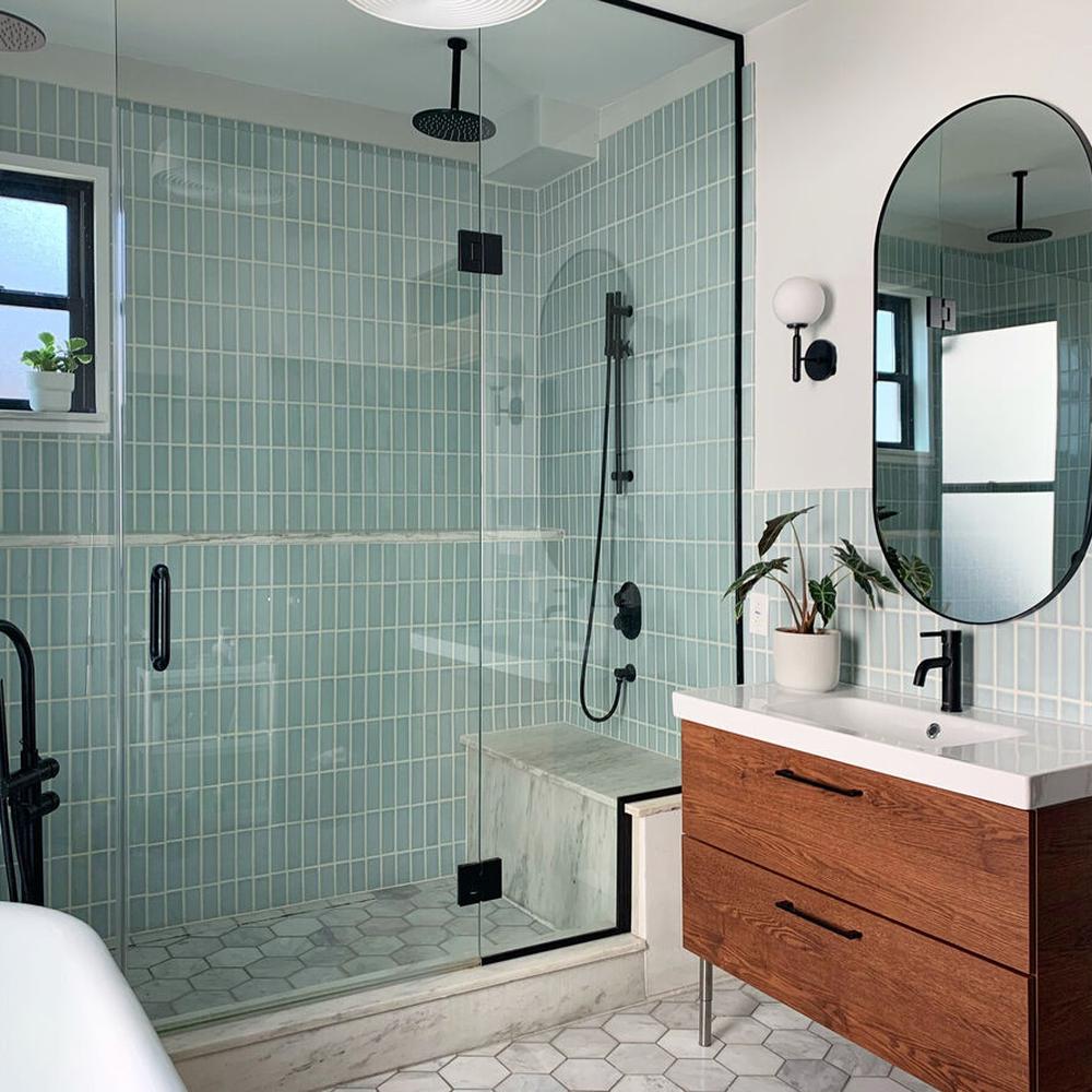 Relaxing contemporary bathroom with mint green tiles and natural accents.
