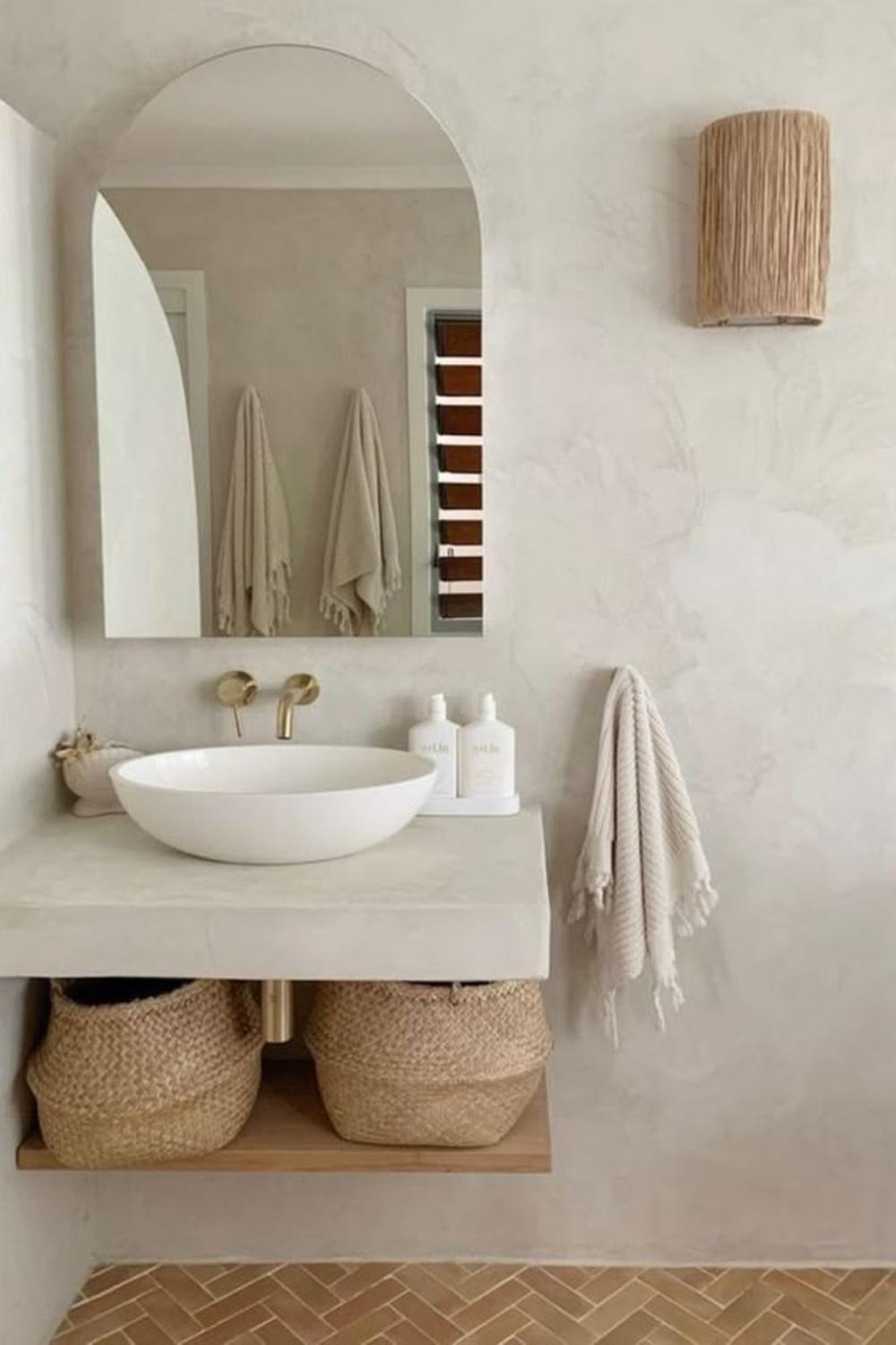Minimalist bathroom vanity with concrete-like countertop and round vessel sink