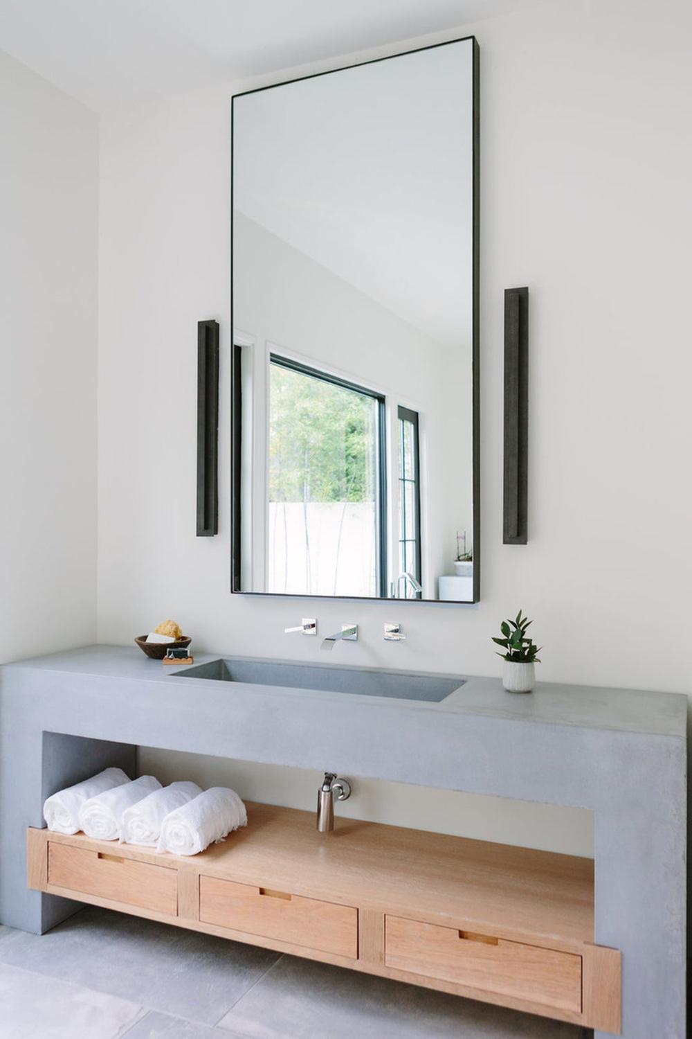 Modern minimalist vanity in concrete style with integrated sink and black faucets