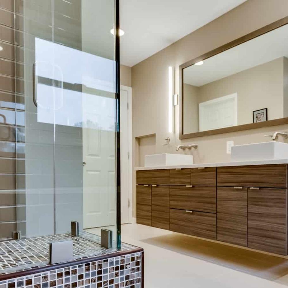 Wall-mounted wooden bathroom vanity with dual above-counter sinks